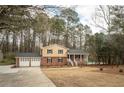 Charming two-story home with brick accents and a pool, surrounded by mature trees at 1106 Oak Sw Rd, Lilburn, GA 30047