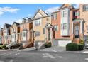 Street view of brick townhomes showcasing architectural details and curb appeal at 1211 Comet View Se Trl, Smyrna, GA 30082