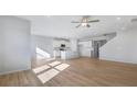 Open-concept living room with hardwood floors seamlessly flowing into the kitchen area at 517 Elkwood Ln, Mcdonough, GA 30253