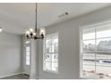 Dining room features an elegant chandelier and large windows at 2554 Hickory Valley Dr, Snellville, GA 30078