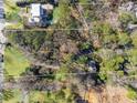 Expansive aerial shot revealing a sprawling lot bordered by mature trees and other large properties at 3200 Wood Valley Nw Rd, Atlanta, GA 30327