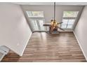 Aerial view of living room with fireplace, ceiling fan, and large windows at 1315 Thunder Gulch Pass, Suwanee, GA 30024
