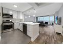 Modern kitchen featuring stainless steel appliances, white countertops, and an open layout with views of the living area at 620 Peachtree Ne St # 503, Atlanta, GA 30308