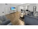 Cozy living room boasts hardwood floors, stylish furnishings, and a large screen TV for relaxation and entertainment at 620 Peachtree Ne St # 503, Atlanta, GA 30308