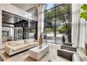 Modern lobby featuring comfortable seating, marble accents, and expansive windows offering views of the surrounding cityscape at 620 Peachtree Ne St # 503, Atlanta, GA 30308