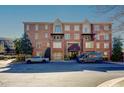 Brick apartment building featuring multiple stories, balconies, and well-manicured landscaping in a residential neighborhood at 1735 Peachtree Ne St # 227, Atlanta, GA 30309