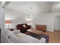 Inviting living room with hardwood floors, a neutral sofa, and a red loveseat under soft, ambient lighting at 1735 Peachtree Ne St # 227, Atlanta, GA 30309