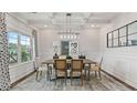 Bright dining room with coffered ceiling, stylish light fixture, and large window at 2396 Cadenza Cir, Dacula, GA 30019