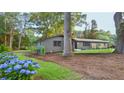 Well-maintained front yard with lush hydrangeas, mature trees and a charming home at 642 Austin Se Dr, Smyrna, GA 30082