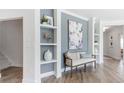 Stylish hallway with built-in shelving, modern decor, and neutral paint colors at 325 Sassafras W Way, Holly Springs, GA 30115