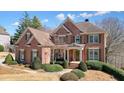 Elegant brick residence boasting a symmetrical facade and inviting front porch at 586 Devon Brooke Dr, Woodstock, GA 30188