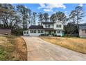 Charming two-story home with a well-maintained yard and a long driveway leading up to the property at 2583 Bronco Trl, Duluth, GA 30096