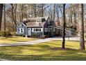 Attractive blue home featuring a long driveway and a serene wooded backdrop at 2858 Skyland Ne Dr, Brookhaven, GA 30341