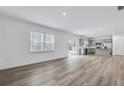 Spacious living room showcasing hardwood floors, natural light, and an open floor plan flowing to the kitchen at 3204 Birdsong Ave, Covington, GA 30016