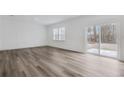 Bright living room with hardwood floors and a sliding glass door that leads to the backyard at 3204 Birdsong Ave, Covington, GA 30016