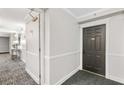 A hallway leading to a unit's door, showcases neutral decor and well-maintained surroundings at 795 Hammond Dr # 801, Atlanta, GA 30328