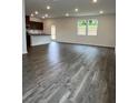 Bright living area with dark wood flooring and windows overlooking the yard at 203 Groveton Ct, Euharlee, GA 30145