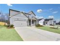 Charming gray home with a spacious driveway, a cozy front porch, and neighborhood view at 362 Rock View Ln, Covington, GA 30016