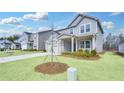 Charming gray home with a well-manicured lawn, a cozy front porch, and neighborhood view at 362 Rock View Ln, Covington, GA 30016