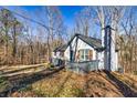 Side view of a well-maintained single-story home with wood accents at 387 Pine Trail, Canton, GA 30115