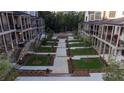 A meticulously landscaped community space sits between townhomes with green space and walkways at 315 Chiswick Cir # 38, Alpharetta, GA 30009