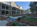 Upscale townhomes with covered porches overlook manicured landscaping at 315 Chiswick Cir # 38, Alpharetta, GA 30009