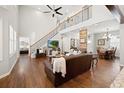 Inviting living room with high ceilings, hardwood floors, and an open staircase at 3564 Suwanee Creek Rd, Suwanee, GA 30024