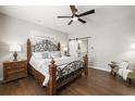 Cozy main bedroom with dark wood floors, a decorative bed frame and a sliding barn door at 3564 Suwanee Creek Rd, Suwanee, GA 30024