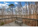 Open deck featuring a seating bench overlooking a serene wooded area and blue skies at 3669 Clearbrooke Way, Duluth, GA 30097
