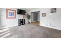 Cozy living room with carpeted floors and view to a room with hardwood floors at 1082 Green Valley Nw Dr, Conyers, GA 30012