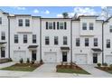 Charming townhomes with white exteriors, black accents, garages, and beautiful curb appeal at 3154 Washburn Sw St, Atlanta, GA 30354