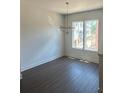 The modern dining area has hard wood floors, a modern light fixture and natural lighting at 962 Bibbs Circle # 5, Atlanta, GA 30318