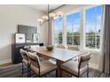 Modern dining room with a wooden table, six chairs, pendant lighting, and large window at 962 Bibbs Circle # 5, Atlanta, GA 30318