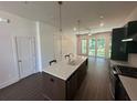 Bright open kitchen with center island featuring a sink and stainless steel appliances at 962 Bibbs Circle # 5, Atlanta, GA 30318