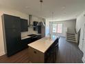 Modern kitchen features an island with seating, stainless appliances, and lots of light at 962 Bibbs Circle # 5, Atlanta, GA 30318