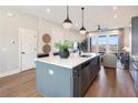 Open kitchen with a gray kitchen island, stainless steel appliances, and views into the living area at 962 Bibbs Circle # 5, Atlanta, GA 30318