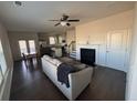 Inviting living room with a fireplace, ceiling fan, and hardwood floors leading to an eat-in kitchen at 2256 Triple Crown Ln, Lithonia, GA 30058