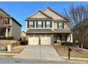 Traditional two-story home boasts a well-manicured lawn and convenient two-car garage at 2359 Brynfield Cv, Suwanee, GA 30024