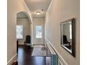 Inviting hallway features hardwood floors, an elegant mirror, and a bright front door at 2359 Brynfield Cv, Suwanee, GA 30024