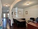 Spacious home office with hardwood floors, a large desk, and natural light at 2359 Brynfield Cv, Suwanee, GA 30024