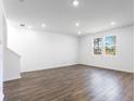 Spacious living room featuring wood-look flooring, recessed lighting and bright windows at 204 Groveton Ct, Euharlee, GA 30145