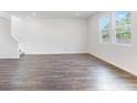 Living room featuring wood-look flooring, recessed lighting and bright windows at 204 Groveton Ct, Euharlee, GA 30145