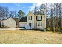 View of a two-story home featuring a two-car garage and classic design at 581 Victorian Cir, Dallas, GA 30157