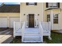 Close up on the home's covered front porch with painted wood railings at 581 Victorian Cir, Dallas, GA 30157