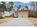 Charming two-story home with a well-manicured front yard and attached two-car garage at 608 Ridge Crossing Dr, Woodstock, GA 30189