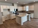 Modern kitchen with granite countertops, stainless steel appliances, and a center island at 986 Sutherland Ln (Lot 32), Lawrenceville, GA 30043