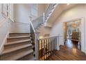 Elegant stairway featuring wooden steps and iron railing with lots of natural light at 1074 Fairway Ne Ests, Atlanta, GA 30319