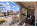 Cozy front porch with comfortable seating and a view of the neighborhood at 112 Rocky Creek Trl, Woodstock, GA 30188