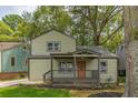 Charming two-story home featuring a covered front porch and well-manicured lawn at 1748 Alvarado Sw Ter, Atlanta, GA 30310