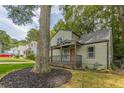 Charming two-story home featuring a covered front porch and well-manicured lawn at 1748 Alvarado Sw Ter, Atlanta, GA 30310